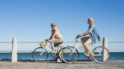 happy couple on a bike ride on the pier