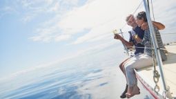 senior couple on the Bow of a Sail Boat 