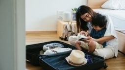 mother and child packing for a trip
