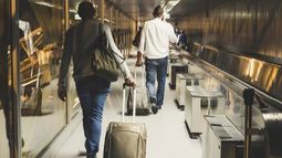 travelers with luggage in airport