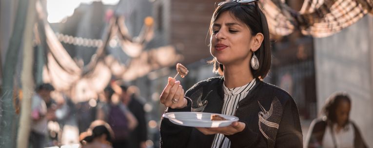 Allianz - woman eating at food festival