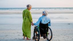 two senior travelers on the beach